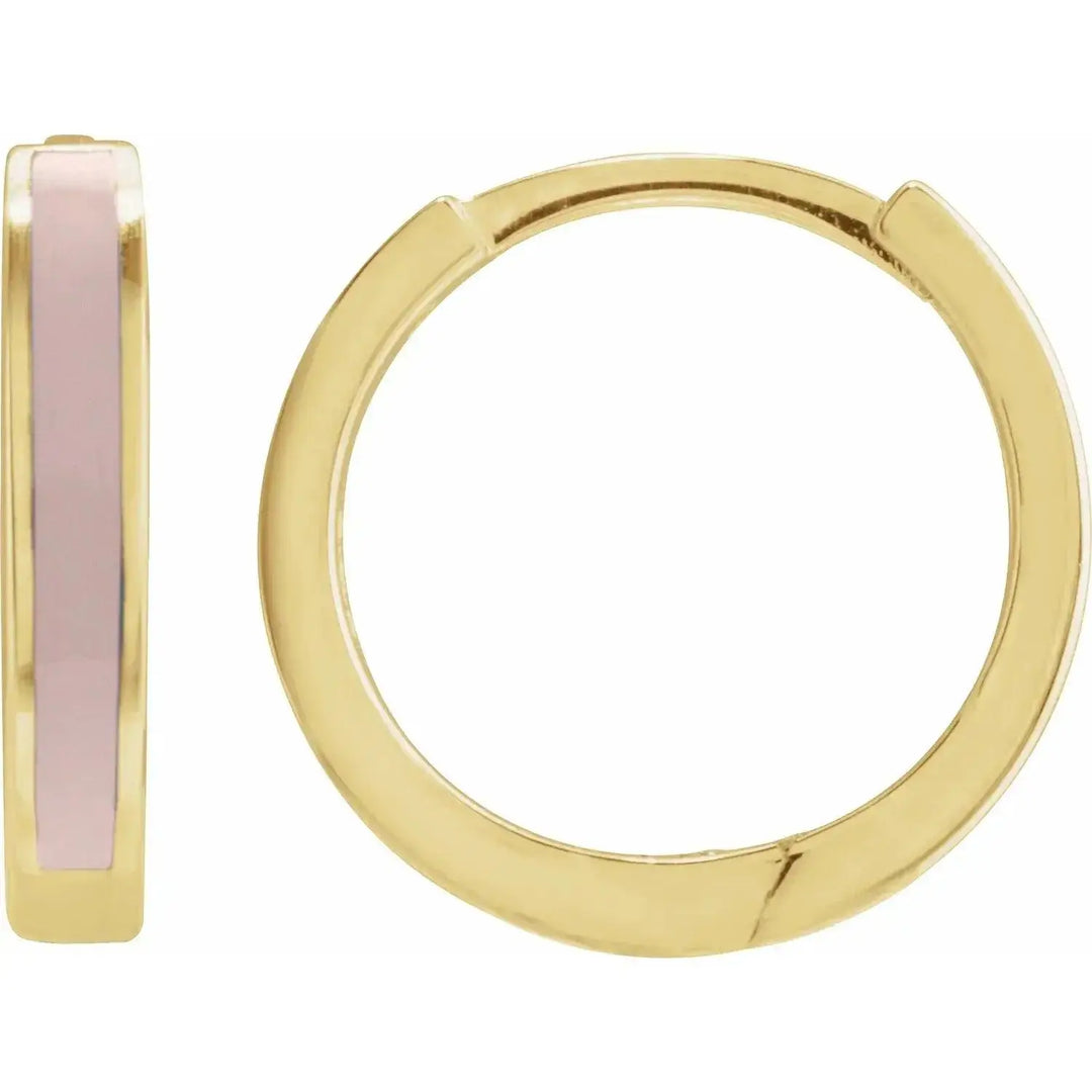 Pink enamel hoop earrings in solid gold with a sleek hinged clasp. These modern gold hoops feature a vibrant pink enamel accent for a stylish touch.