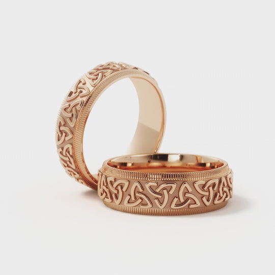 Pair of Trinity Celtic wedding rings in 14K rose gold with 6mm bands. Handcrafted with intricate knot designs for a timeless and symbolic look.