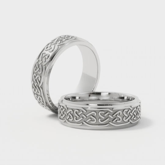 Pair of 6mm White Gold Celtic Wedding Rings with love knot engravings. A handcrafted symbol of everlasting love, perfect for couples seeking timeless jewelry.