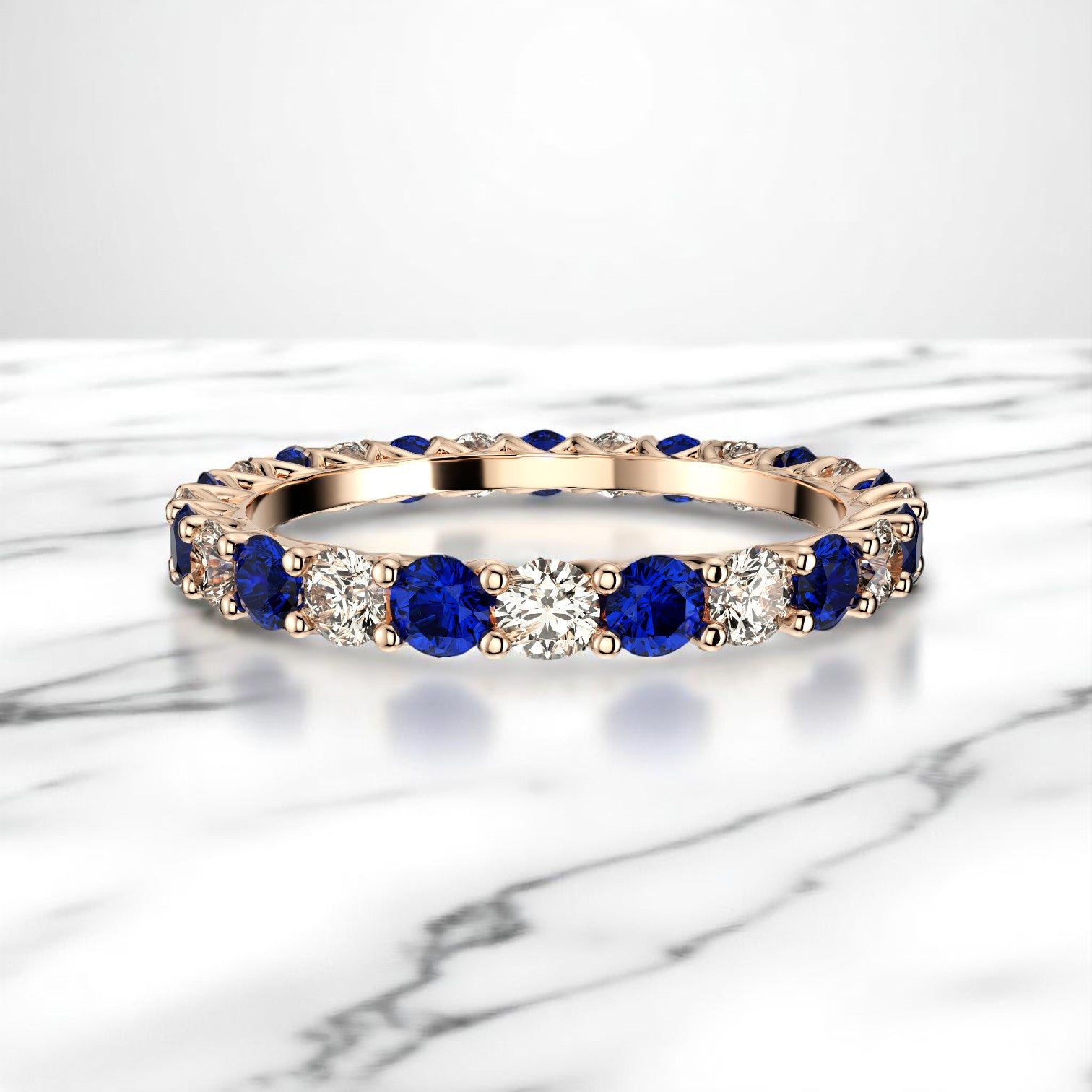 14K rose gold eternity band with blue sapphire and diamond stones