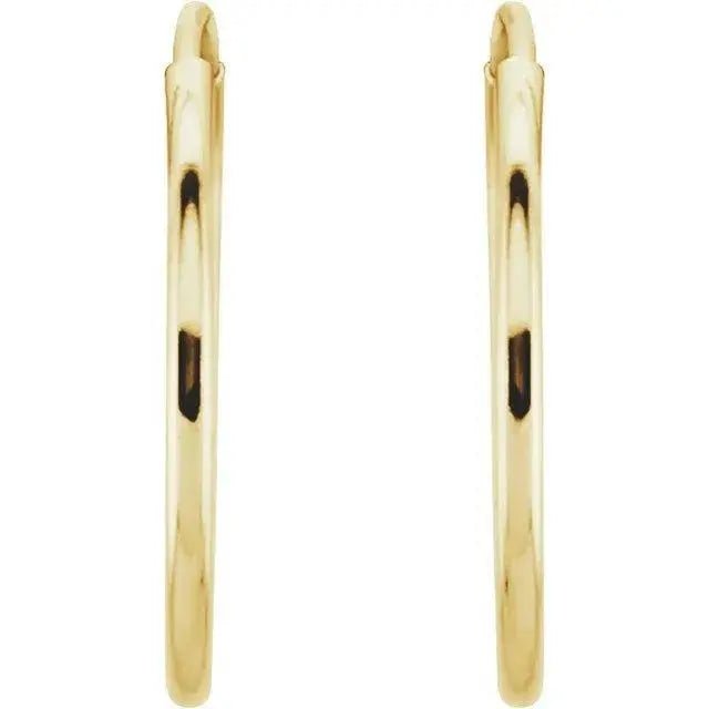 Close-up of 14K gold endless hoop earrings with smooth finish