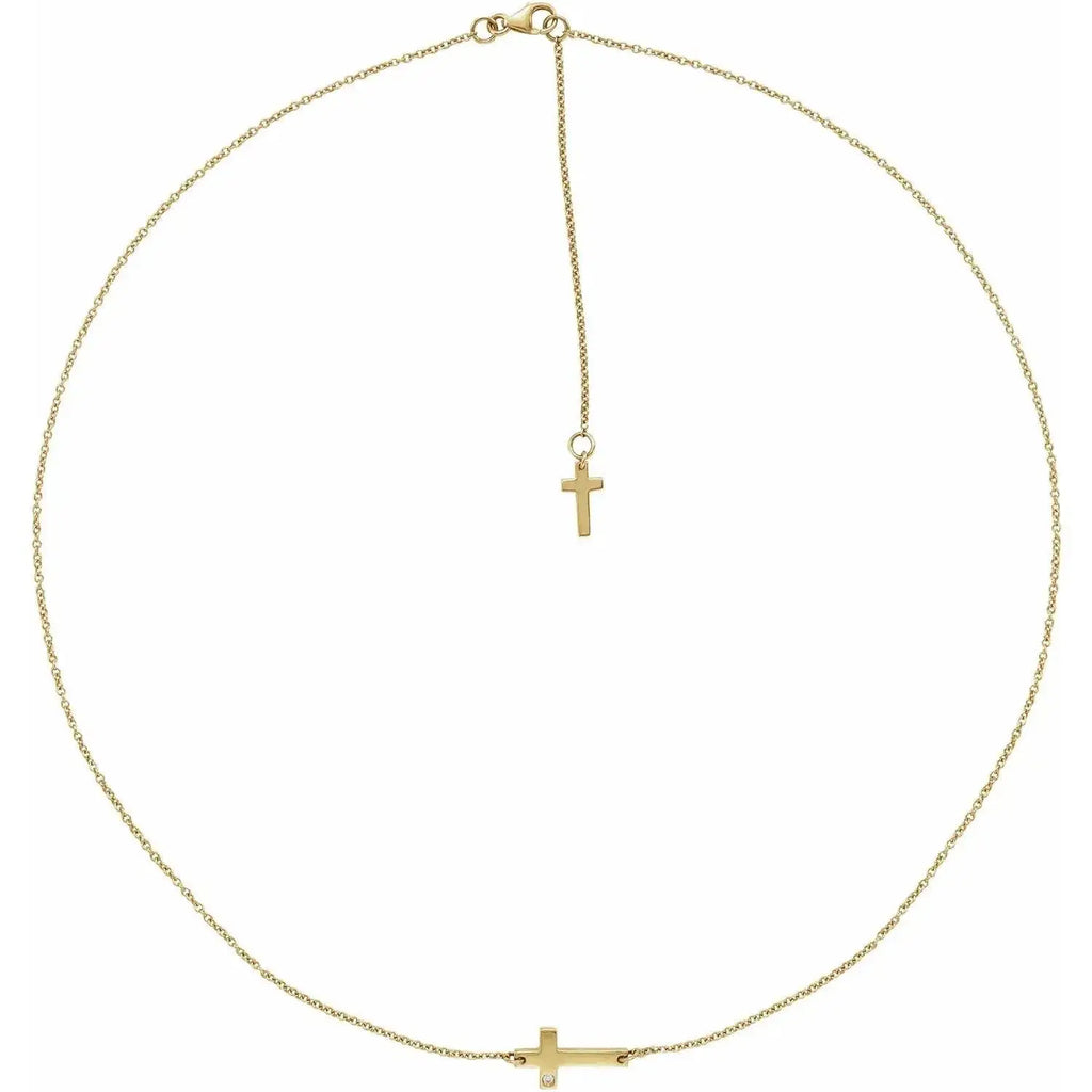 Close-up photo of 14K gold sideways cross necklace with adjustable chain, handcrafted in NYC.