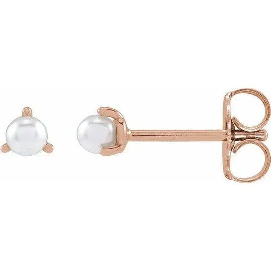 Close-up of a natural white pearl earring in platinum setting