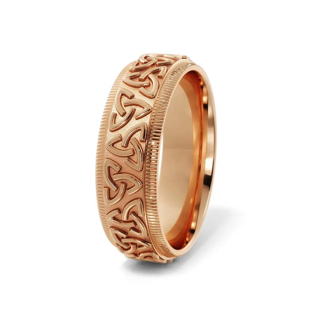 Men's Trinity Celtic wedding ring in 6mm 14K rose gold with detailed knot engravings. A symbolic and elegant handcrafted gold wedding band.