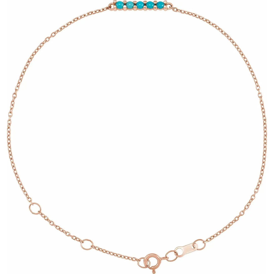 Rose gold turquoise bolo bracelet with a minimalist chain and five turquoise gemstones. Adjustable and handcrafted for a timeless look.