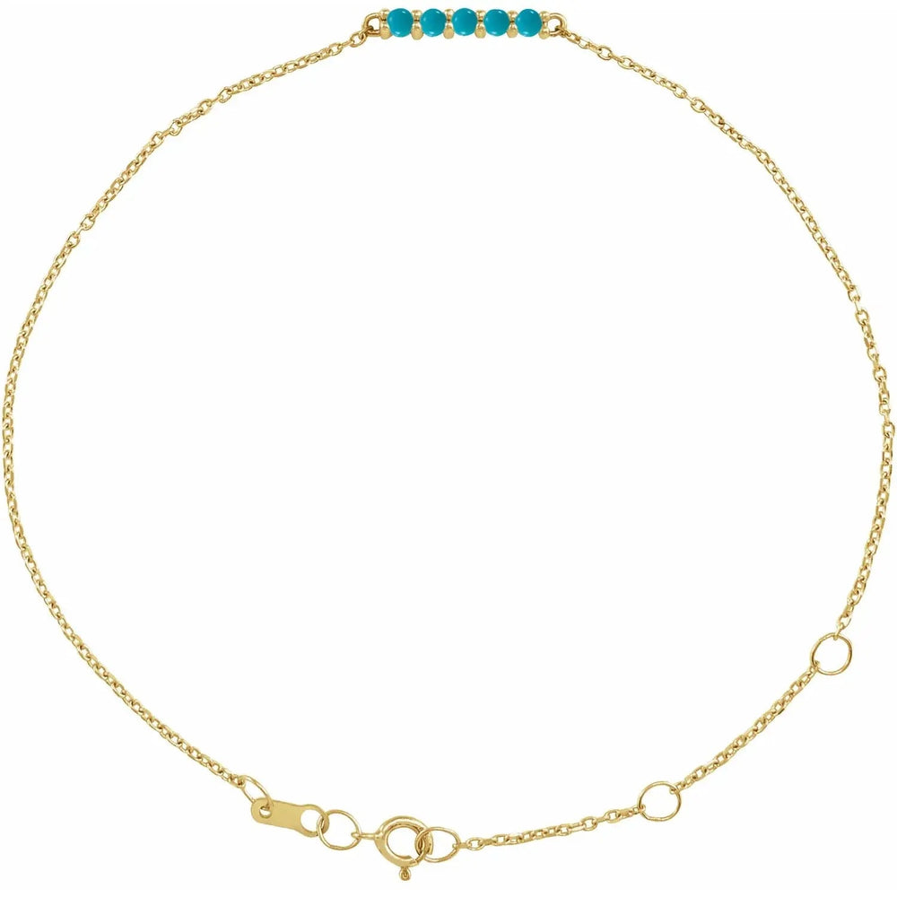 Gold turquoise bolo bracelet with a dainty chain and five natural turquoise gemstones. A stylish and adjustable jewelry piece for any occasion.