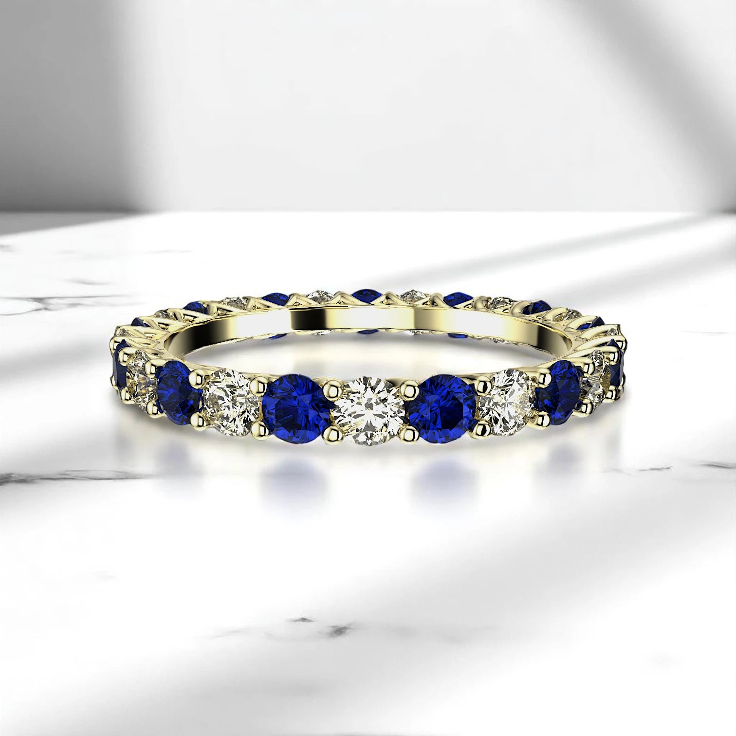 Alternating sapphire and diamond ring in yellow gold prong setting